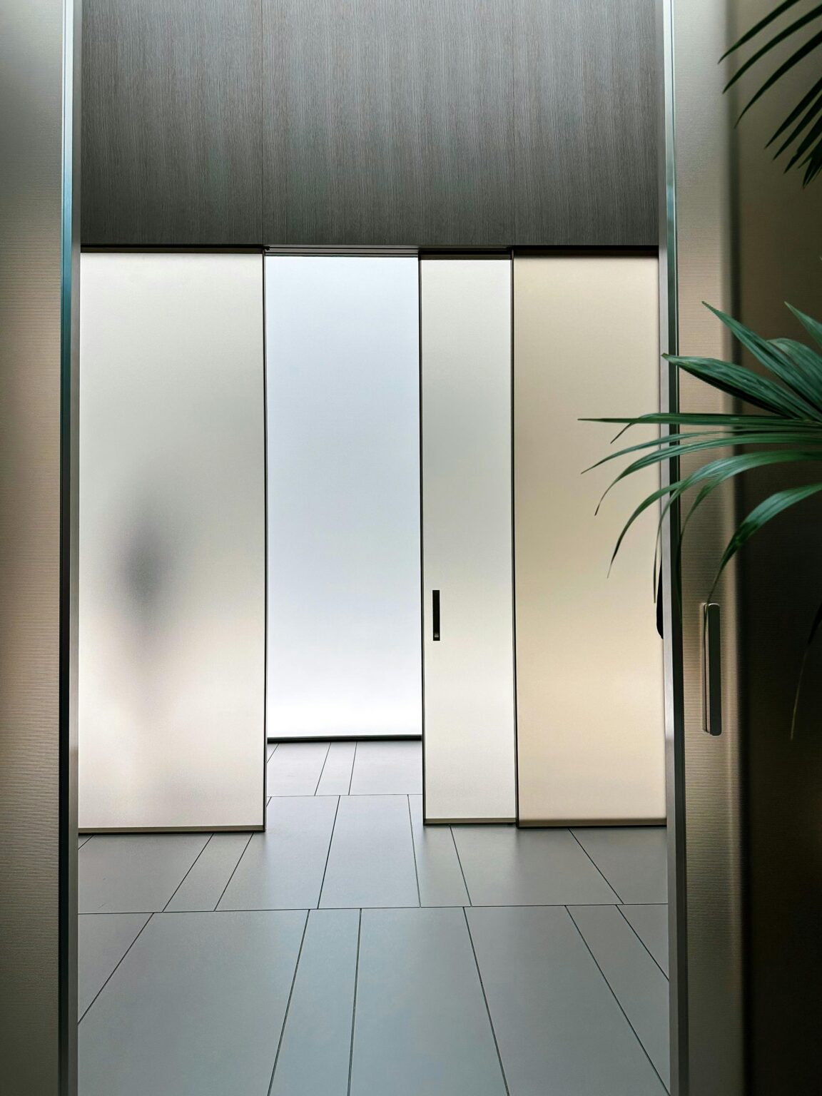 Sleek interior design with frosted glass sliding doors and ambient lighting